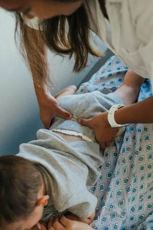 Chiropractor Rancho Cucamonga CA Emily Ronduen Bautista Dr. Emily Ronduen Bautista adjusting a baby with the help of the child's mother